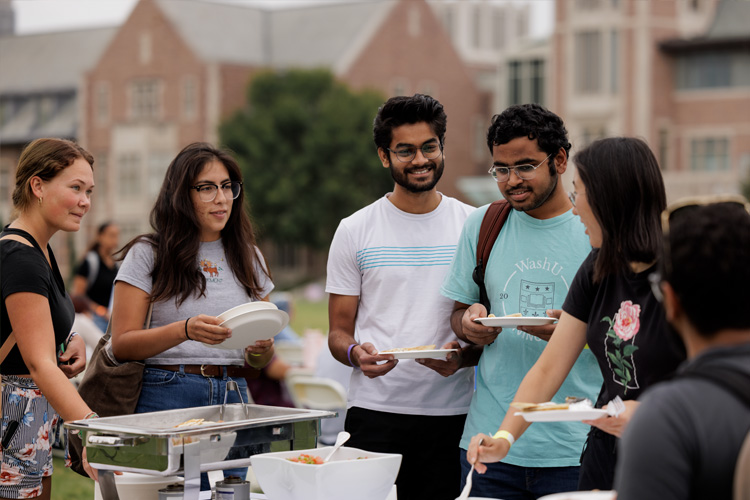 students get food at buffet outside